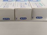 three boxes of toothpaste sitting on top of a white counter