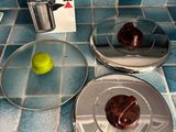 three donuts sitting on a plate on the kitchen counter