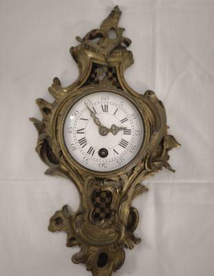 a clock that is on the wall with a bird on it