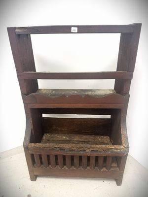 an old wooden shelf with a shelf on top of it