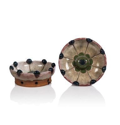pair of ceramic bowls with black and green decorations on them
