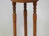 a small wooden table with a clock on top of it