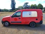 a red van that is parked in a field