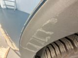 a close up of a car ' s front bumper and tire