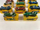 several toy cars are lined up in a row on a white surface