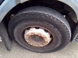 a flat tire on the side of a truck