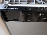 a black and white picture of a dishwasher with the door open