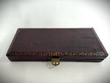 an old brown box with a lock on a white surface