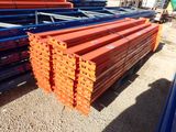orange steel beams stacked on top of each other in a pile