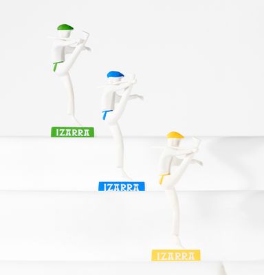 three figurines that are standing on a white surface