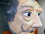 a large head of a man that is in a room