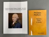 two books on a table with a picture of a man in a blue coat
