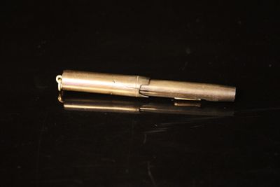 a pen that is laying on a black surface