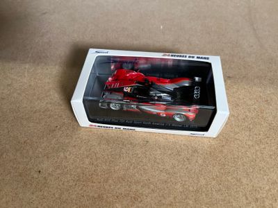 a box with a toy motorcycle in it on a table