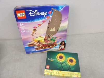 a box of legos with a picture of a boat and sunflowers on it