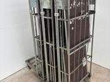 a metal cage with a bunch of luggage in it