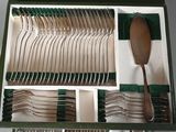 many forks and spoons in a box with a spoon in it