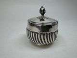 an image of a silver bowl with a bird on top