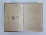an open book with writing on it sitting on top of a table