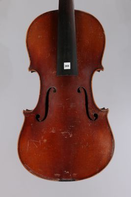 an old violin sitting on top of a white surface