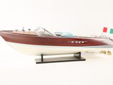a model of a boat on a stand on a white surface