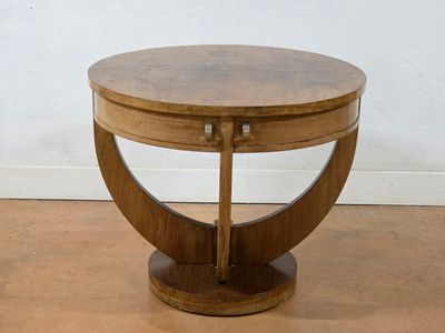 a small wooden table with a circular top