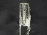 a glass vase that is sitting on a black surface