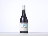 a bottle of red wine sitting on top of a table