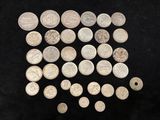 an image of a pile of silver coins on a black surface