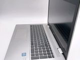 a silver laptop with a blue sticker on the screen