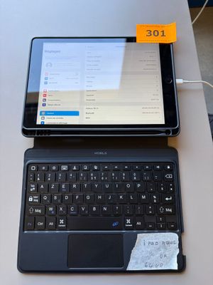 a laptop and a tablet on a table with a price tag