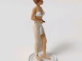 a figurine of a woman holding a tennis racquet on a coin