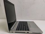 an open laptop computer sitting on top of a white table