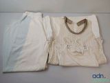 a white shirt and white pants on a table