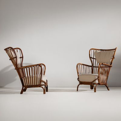 two chairs in a room with a white wall and a white floor