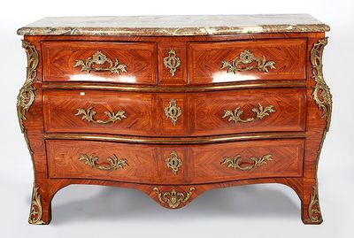 a wooden chest of drawers with a marble top