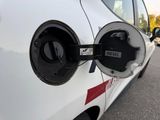 a close up of an electric car charging on the street