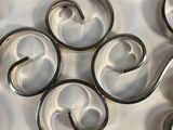 a lot of metal swirls that are on a table