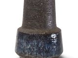 a blue and black vase sitting on a white surface