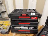 a stack of tools sitting on a workbench in a room