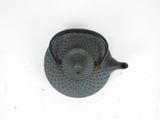 a teapot with a tea strainer attached to it