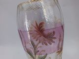 a glass vase with a floral design on it