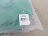 a bag of green gloves sitting on the floor