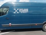 a blue van that is parked in a parking lot