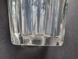 a clear glass vase with a small amount of water in it