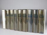 six books in a row on a white surface