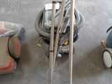 two vacuums and a baby car seat on the floor
