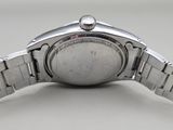 an image of a close up of a watch on a white surface