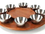 a wooden plate with six bowls on it on a white background