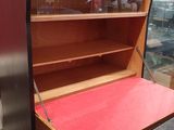a small desk with a red top in a room
